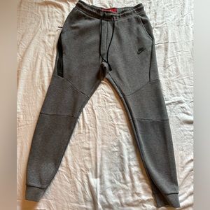 Gently worn Nike Tech Joggers, dark grey with black accents. Men’s size small.